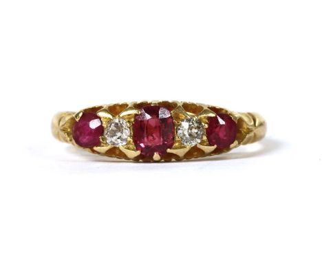 An 18ct gold ruby and diamond five stone ring, with a graduated row of mixed cut rubies, one later replacement, and old brill