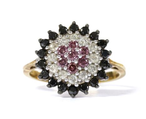 A 9ct gold treated diamond cluster ring, with a central seven stone cluster of treated pink brilliant cut diamonds, to surrou