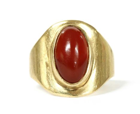 A 9ct gold single stone cornelian ring, with an oval cabochon cornelian, rub set, to tapered head and a flat section shank, S