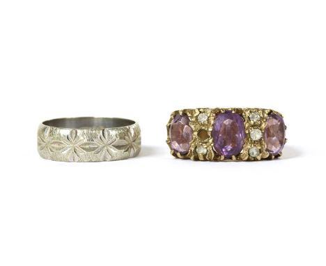 A 9ct white gold patterned wedding ring, London 1975, together with a 9ct gold amethyst and paste ring, one paste deficient, 