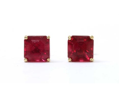 A pair of gold single stone fracture filled ruby stud earrings, with an octagonal mixed cut fracture filled ruby, approximate