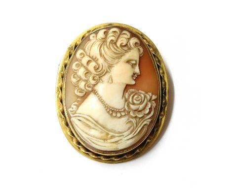 A gold mounted shell cameo brooch, the cameo depicting the portrait of a lady, rub set, to twisted wire frame, with pin and s