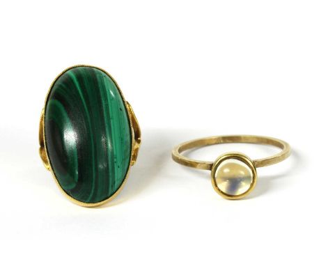 A gold single stone malachite ring, with an oval cabochon malachite, approximately 28 x 16mm, milligrain set, to split should