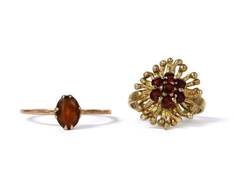 A 9ct gold garnet cluster ring, with a seven stone garnet cluster, claw set, to naturalistic surround, and a 'D' section shan