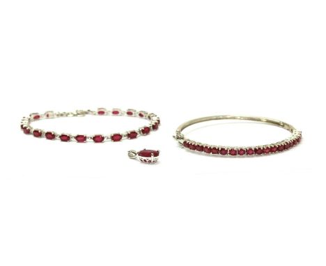 A sterling silver fracture filled ruby line bracelet, with a row of oval mixed cut fracture filled rubies, approximately 6 x 