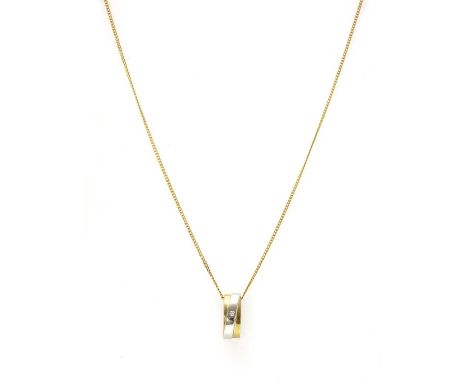 A two colour gold diamond pendant, flush set with a brilliant cut diamond, tested as approximately 9ct gold, suspended on a c