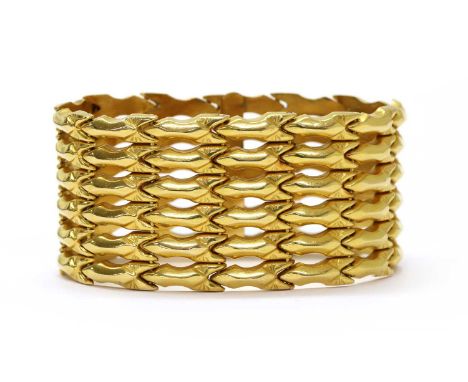 A gold bracelet, with six rows of hollow arrow shaped links, to box clasp and two figure of eight safety catches, tested as a