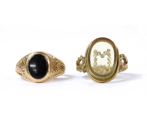  A gold diamond and resin set initial 'M' ring, tested as approximately 9ct gold, together with a gold onyx signet ring, test