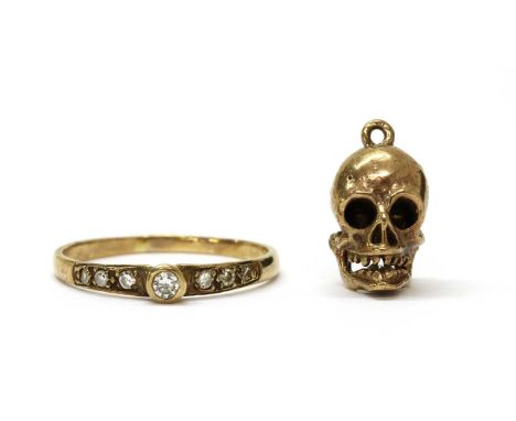 A 9ct gold diamond set ring, London, together with a gold articulated skull charm, tested as approximately 9ct gold, 3.57g (2