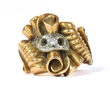 A gold diamond set scroll ring, the scroll head grain set with an eight cut diamond, two diamonds deficient, to tapered shoul