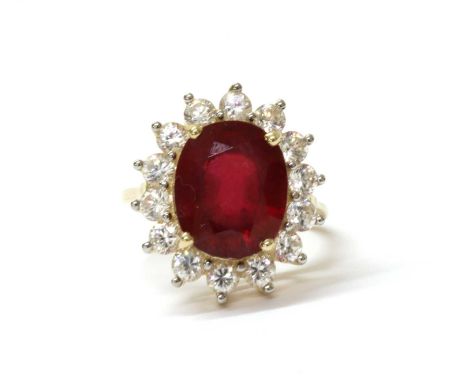 A 9ct gold fracture filled ruby and zircon cluster ring, with an oval fracture filled ruby, approximately 12 x 10mm, to surro