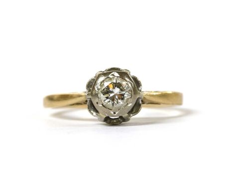 A gold single stone diamond ring, with a brilliant cut diamond grain set to a high white gold illusion collet, to yellow gold