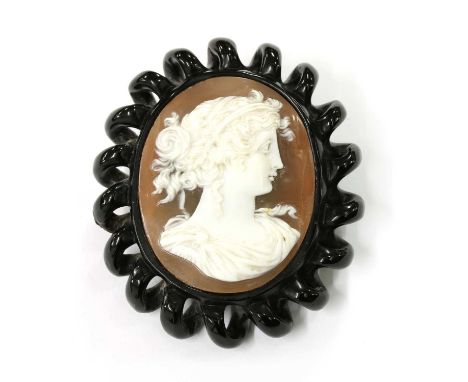 A jet cameo brooch/pendant, with a shell cameo depicting the portrait of a lady, to carved spiral jet surround, with silver b