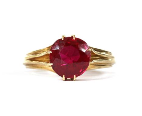 A gold single stone synthetic ruby ring, tested as approximately 14ct gold, 4.51g.Finger size NCondition report: Minor surfac