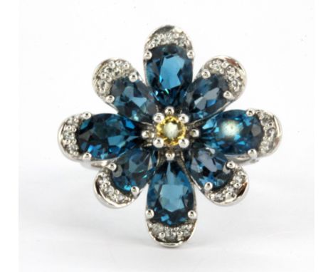 A 925 silver flower shaped ring set with oval cut London blue topaz and citrines, (O.5).