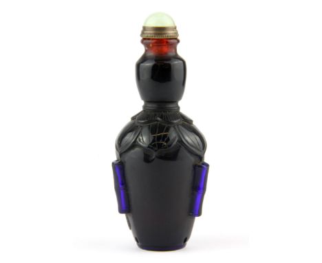 A Chinese carved two layer Peking cameo glass snuff bottle with carrying handles and jade stopper, H. 10.5cm.