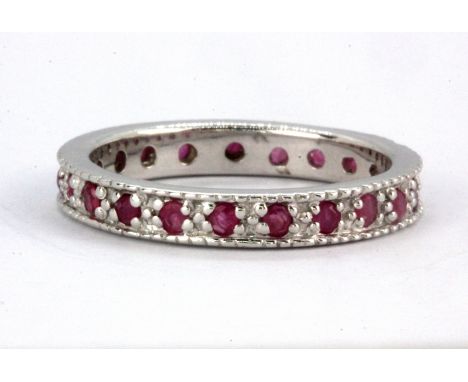 A 925 silver ruby set full eternity ring, (N).