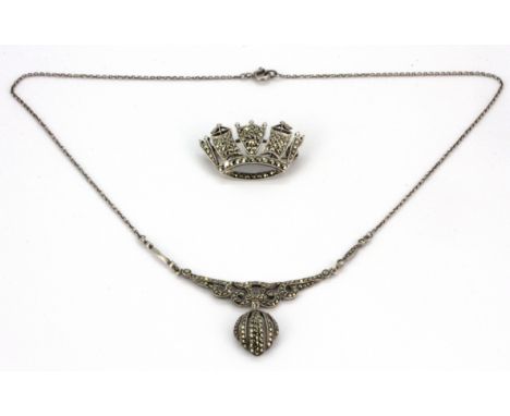 A sterling silver and marcasite necklace together with a silver and marcasite brooch.