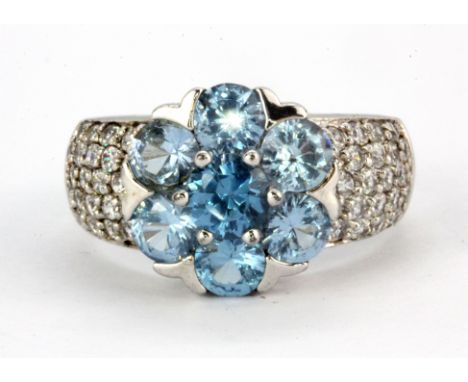 A 925 silver flower shaped cluster ring set with Swiss blue topaz and stone set shoulders, (S.5).
