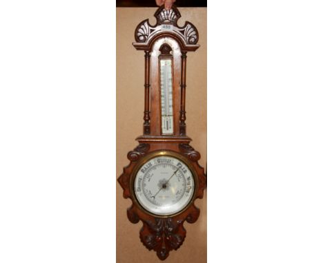 A carved oak barometer, H. 90cm.