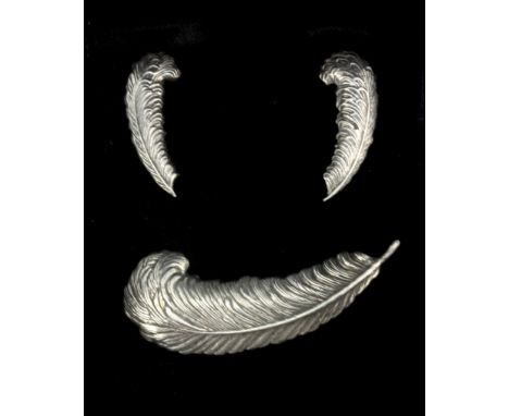 A sterling silver feather shaped brooch and pair of matching screw back fitted earrings.