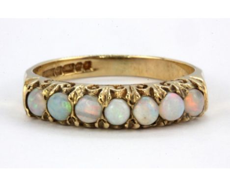 A 9ct yellow gold cabochon cut opal set half eternity ring, (N).