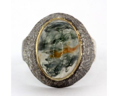 A silver ring set with cabochon cut moss agate, (N).
