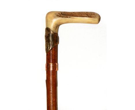 An American carved antler and brass handled swordstick, L. 83cm.