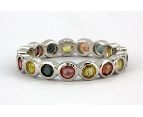 A 925 silver full eternity ring set with fancy coloured sapphires, (Q).