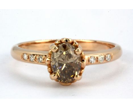 An 18ct rose gold (stamped 750) solitaire ring set with 1.05ct oval cut fancy deep brown diamond and diamond set shoulders, (