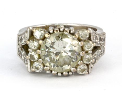 A boxed white metal (tested 18ct gold) ring set with a centre brilliant cut diamond and diamond set shoulders, centre diamond