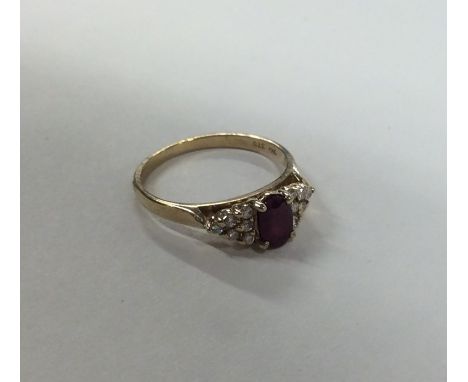 A ruby and diamond thirteen stone cluster ring in claw mount. Approx. 2.1 grams. Est. £60 - £80.