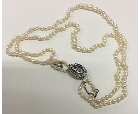 A good Georgian double string of pearl beads with gold mounted clasp. Approx. 27 grams. Est. £100 - £150.