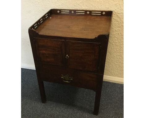 A Georgian mahogany two door commode with fretwork gallery. Est. £50 - £80.