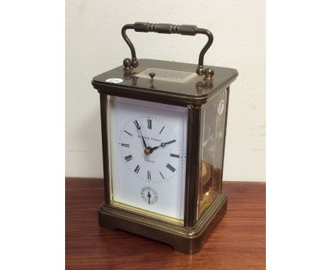 A large brass striking carriage clock with white enamelled dial. Est. £100 - £200.
