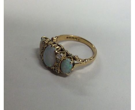 An 18 carat gold opal and diamond nine stone ring i claw mount. Approx. 4 grams. Est. £150 - £200.