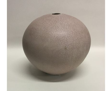 DAVID LEACH (British: 1911 - 2005): A spherical porcelain pottery vase with small opening to top in pink crackle pattern. Imp