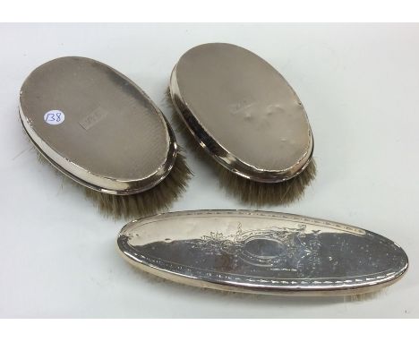 A pair of silver mounted hair brushes of engine turned decoration. Est. £20 - £30.