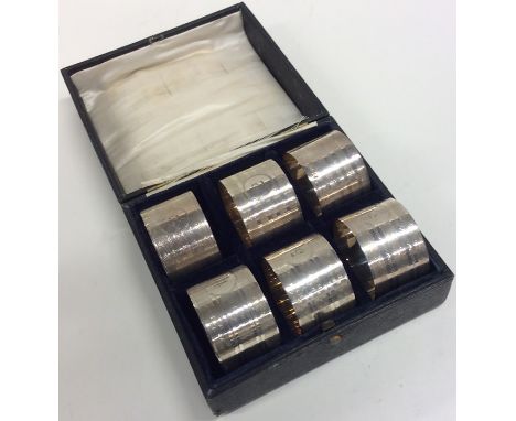 CHESTER: A good set of six silver engine turned napkin rings contained within a fitted box. By AW. Approx. 150 grams. Est. £1