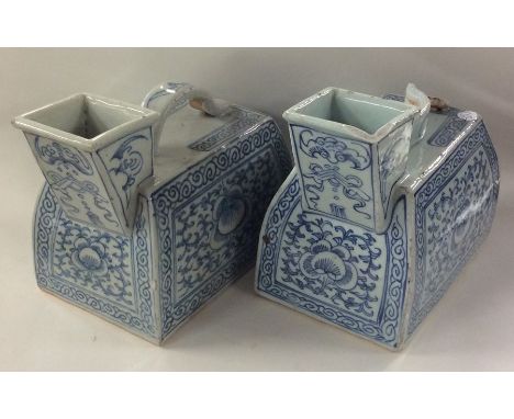 A pair of Chinese blue and white water jugs with scroll handles and wriggle work borders. Approx. 15 cms high each. Est. £80 
