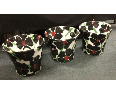 JANICE TCHALENKO (British: 1942 - 2018): A matched set of three large 'Black Rose' design Dartington planters of tapering for