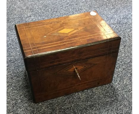 A walnut tea caddy with fitted interior. Est. £20 - £30.