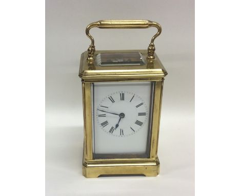 A rectangular brass mounted carriage clock with white enamelled dial together with key. Est. £100 - £150.