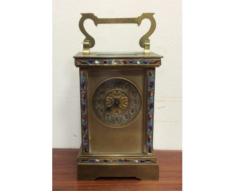 A brass mounted and cloisonné carriage clock with gilt dial to bracket feet. Est. £60 - £80.