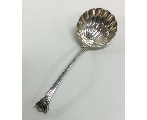 A Georgian silver sauce ladle with fluted bowl and turned stem. Approx. 42 grams. Est. £30 - £40.
