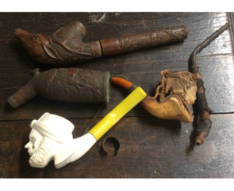 An old wooden carved pipe etc. Est. £20 - £30.