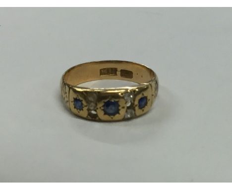 An 18 carat gold sapphire and diamond ring. Approx. 4 grams. Est. £60 - £80.