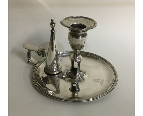 A George III silver chamber stick with crested side together with matching extinguisher. London 1794. By Hannon &amp; Crouch.