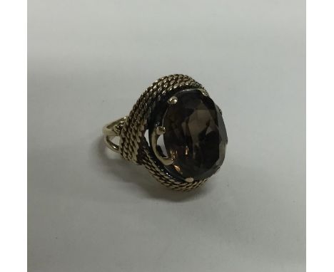 A large 9 carat smoky quartz single stone ring. Approx. 8.7 grams. Est. £80 - £100.