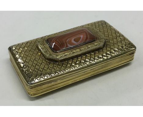 A good quality Antique silver gilt snuff box with weave decoration and central hard stone. Approx. 66 grams. Est. £120 - £150